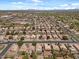 Neighborhood aerial view of a community with tile roofs, desert landscaping, and mature trees throughout at 1703 E Palo Blanco Way, Gilbert, AZ 85296