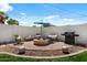 Inviting backyard with fire pit, seating, and barbecue, ideal for outdoor gatherings at 1703 E Palo Blanco Way, Gilbert, AZ 85296