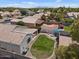 This backyard features a grassy area, a fire pit, a patio with an umbrella, and a pergola covered patio at 1703 E Palo Blanco Way, Gilbert, AZ 85296