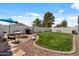 Beautiful backyard features a cozy fire pit area and lush green lawn perfect for relaxation at 1703 E Palo Blanco Way, Gilbert, AZ 85296