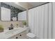 Stylish bathroom with white vanity, wallpapered accent wall, and combination shower and tub at 1703 E Palo Blanco Way, Gilbert, AZ 85296