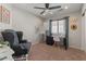 Cozy bedroom with large chair, desk, carpet, and natural light at 1703 E Palo Blanco Way, Gilbert, AZ 85296