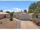 Charming single-Gathering home boasting mature landscaping and a well-maintained two-car garage, set against a clear blue sky at 1703 E Palo Blanco Way, Gilbert, AZ 85296