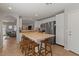 Modern kitchen with tile flooring, stainless steel appliances, white cabinets, and a butcher block island with bar stools at 1703 E Palo Blanco Way, Gilbert, AZ 85296