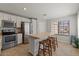 Bright kitchen featuring stainless steel appliances, white cabinetry, tile flooring, and a butcher block island with seating at 1703 E Palo Blanco Way, Gilbert, AZ 85296
