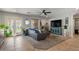 Bright living room with tile flooring, neutral walls, a ceiling fan, and French doors leading to the backyard at 1703 E Palo Blanco Way, Gilbert, AZ 85296
