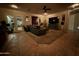 Living room featuring tile flooring, a ceiling fan, a TV, and sliding doors leading to the backyard at 1703 E Palo Blanco Way, Gilbert, AZ 85296