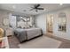 Relaxing primary bedroom featuring a ceiling fan, neutral tones, and natural light at 1703 E Palo Blanco Way, Gilbert, AZ 85296