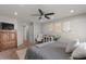 Spacious primary bedroom with a ceiling fan, warm carpet, and dresser at 1703 E Palo Blanco Way, Gilbert, AZ 85296