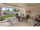 Inviting covered patio with outdoor dining set and views of the landscaped backyard at 1703 E Palo Blanco Way, Gilbert, AZ 85296