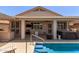 A backyard with a covered patio, hot tub, and barbecue at 18080 W Spencer Dr, Surprise, AZ 85374