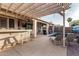 Relaxing backyard with covered patio, swimming pool, bar, and lounge chairs at 18080 W Spencer Dr, Surprise, AZ 85374
