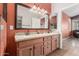 Bathroom features a double sink vanity, granite countertops, and large mirror at 18080 W Spencer Dr, Surprise, AZ 85374