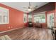 Bright bedroom with many windows, wood floors, a ceiling fan and an accent wall at 18080 W Spencer Dr, Surprise, AZ 85374