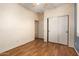 Bright bedroom featuring a ceiling fan, laminate floors, and a closet for storage at 18080 W Spencer Dr, Surprise, AZ 85374