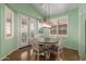 Cozy breakfast nook features a wood table, shuttered windows, and custom lighting at 18080 W Spencer Dr, Surprise, AZ 85374