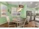 Eat-in dining area featuring plantation shutters and an elegant light fixture at 18080 W Spencer Dr, Surprise, AZ 85374