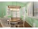 Bright dining area with shuttered windows and modern lighting at 18080 W Spencer Dr, Surprise, AZ 85374