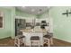 Bright kitchen with an island, stainless steel appliances and bar stool seating at 18080 W Spencer Dr, Surprise, AZ 85374