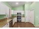Charming kitchen with granite countertops, stainless steel appliances, and ample cabinet space at 18080 W Spencer Dr, Surprise, AZ 85374