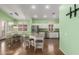 Open concept kitchen features an island with seating, stainless appliances, and breakfast nook at 18080 W Spencer Dr, Surprise, AZ 85374