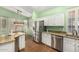 Charming kitchen with granite countertops, stainless steel appliances, and wood-style flooring at 18080 W Spencer Dr, Surprise, AZ 85374