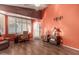 Comfortable living room with wood floors, a ceiling fan, and a view to the front yard at 18080 W Spencer Dr, Surprise, AZ 85374