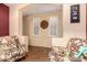 Cozy living room featuring two chairs, decorative wall, and natural light at 18080 W Spencer Dr, Surprise, AZ 85374
