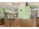 Open floor plan with spacious kitchen, island seating, and wood-style flooring at 18080 W Spencer Dr, Surprise, AZ 85374