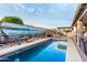Inviting swimming pool with muraled wall, lounge chairs, and outdoor bar area at 18080 W Spencer Dr, Surprise, AZ 85374