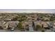 An aerial shot showcases a neighborhood with desert landscaping, mountain views, and single-story homes at 22205 W Ashleigh Marie Dr, Buckeye, AZ 85326