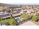 Aerial view of a community featuring homes with solar panels, landscaped yards, pools, and desert foliage at 22205 W Ashleigh Marie Dr, Buckeye, AZ 85326