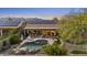 Spacious backyard featuring a freeform pool, rock waterfall, solar panels, and outdoor seating area at 22205 W Ashleigh Marie Dr, Buckeye, AZ 85326