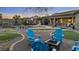 A landscaped backyard featuring a freeform pool, waterfall, fire pit, and seating area for outdoor enjoyment at 22205 W Ashleigh Marie Dr, Buckeye, AZ 85326