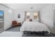 Bright bedroom with large windows, a king-size bed, and gray carpet flooring at 22205 W Ashleigh Marie Dr, Buckeye, AZ 85326