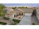 Charming single-story home with a well-manicured lawn, desert landscaping, and a two-car garage at 22205 W Ashleigh Marie Dr, Buckeye, AZ 85326
