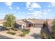 Inviting single-story home with a long driveway, attached garage, and appealing landscaping at 22205 W Ashleigh Marie Dr, Buckeye, AZ 85326