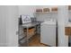 Practical laundry room with washer, sink, and storage baskets on shelves at 22205 W Ashleigh Marie Dr, Buckeye, AZ 85326