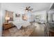 Bright and spacious main bedroom with a king bed, stylish decor, ceiling fan, and sitting area at 22205 W Ashleigh Marie Dr, Buckeye, AZ 85326