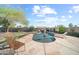 Inviting pool area with umbrellas, lounge chairs, and stone surround at 22205 W Ashleigh Marie Dr, Buckeye, AZ 85326
