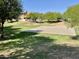 Community basketball court surrounded by green grass and trees at 2539 N 148Th Dr, Goodyear, AZ 85395