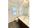 Well-lit bathroom with tiled floor, large mirror, and a shower with glass doors at 2539 N 148Th Dr, Goodyear, AZ 85395