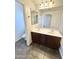 Bathroom with a double sink vanity, large mirror, and a view of a toilet and shower area at 2539 N 148Th Dr, Goodyear, AZ 85395