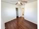 Spacious bedroom featuring wood laminated floors, ceiling fan and closet at 2539 N 148Th Dr, Goodyear, AZ 85395
