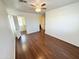 Spacious bedroom boasts wood-look floors, fan, and entrances to a walk-in closet and en-suite bathroom at 2539 N 148Th Dr, Goodyear, AZ 85395