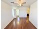 Open bedroom with wood-look flooring and entrances to a walk-in closet and a full bathroom at 2539 N 148Th Dr, Goodyear, AZ 85395
