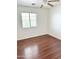 Bedroom featuring laminated wood flooring, a ceiling fan and a window with blinds at 2539 N 148Th Dr, Goodyear, AZ 85395