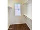 Functional walk-in closet with natural light, wooden rods and shelving for easy organization at 2539 N 148Th Dr, Goodyear, AZ 85395