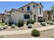 Well-manicured front yard with stone landscaping complements this charming two-story home at 2539 N 148Th Dr, Goodyear, AZ 85395