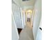 Carpeted upstairs hallway with arched doorways and white walls leading to bedrooms at 2539 N 148Th Dr, Goodyear, AZ 85395